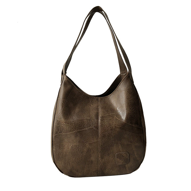 Brown leather handbag on a white background