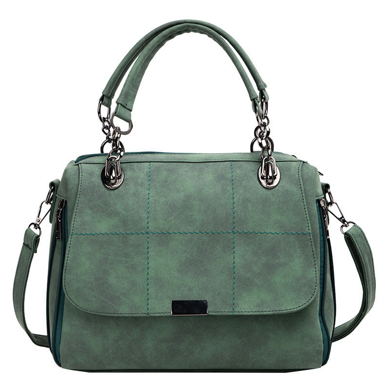 Green handbag with quilted design on a white background