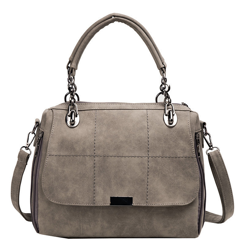 Gray handbag with a shoulder strap on a white background