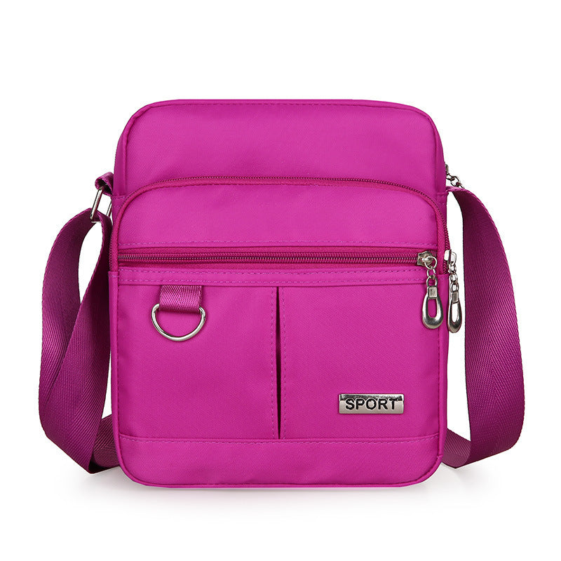 Pink crossbody bag with 'SPORT' label on a white background
