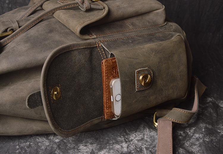 Brown leather bag with a key holder on a dark surface