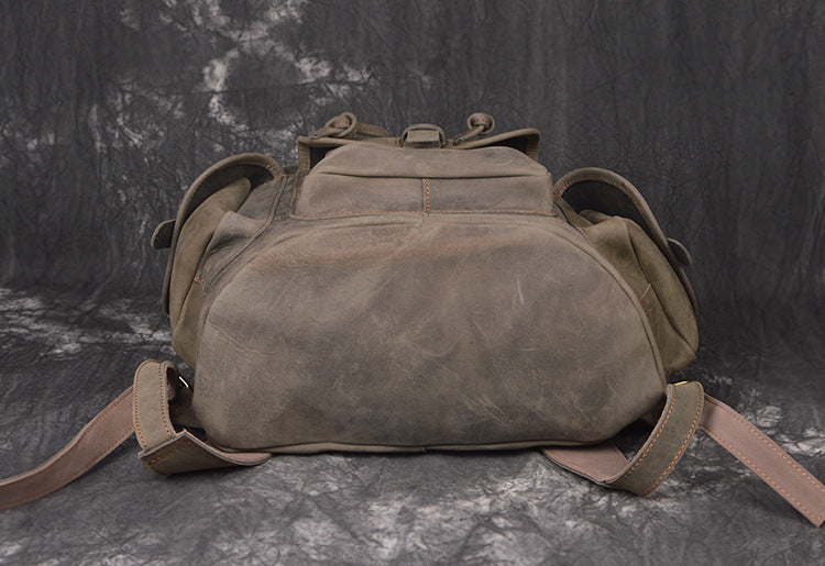 Brown leather backpack on a dark textured background