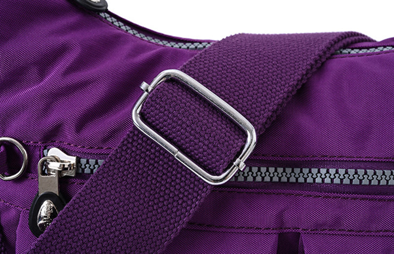 Close-up of a purple bag with a silver buckle and zipper