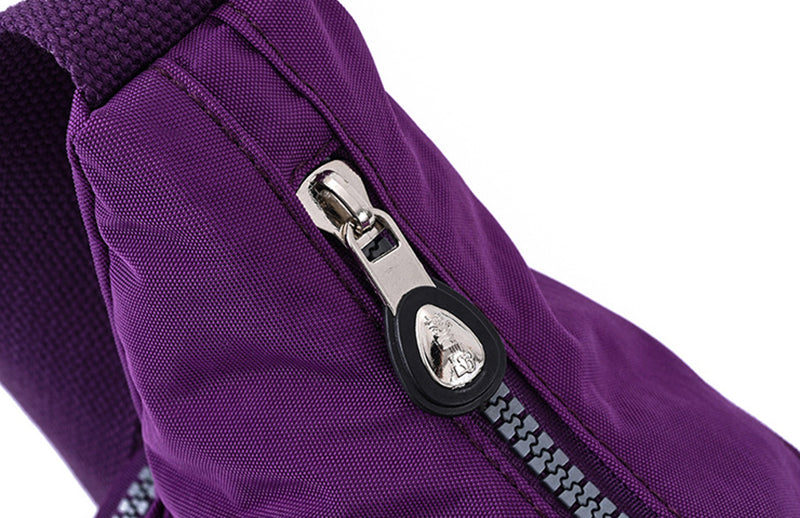 Close-up of a purple bag with a silver zipper on a white background