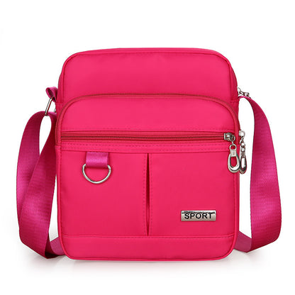 Pink crossbody bag with 'SPORT' label on a white background