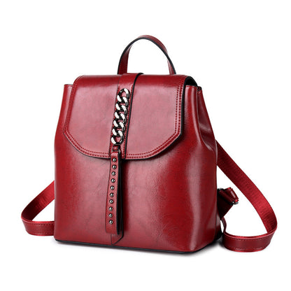 Red backpack with a chain detail on a white background