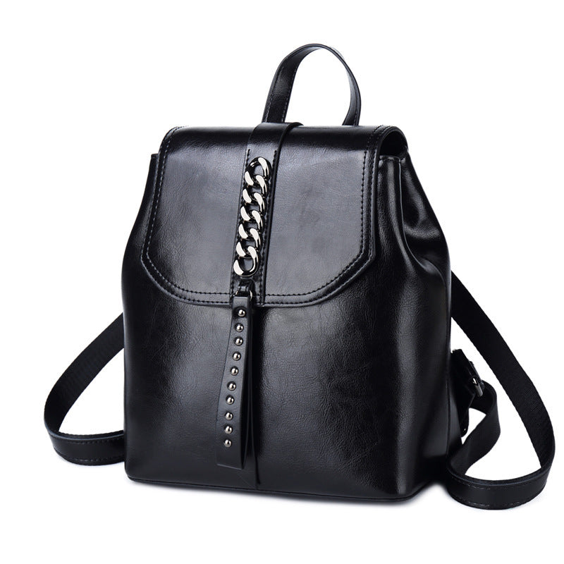 Black leather backpack with chain detail on a white background