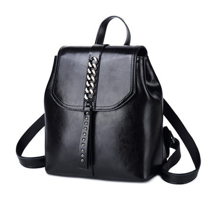 Black leather backpack with chain detail on a white background