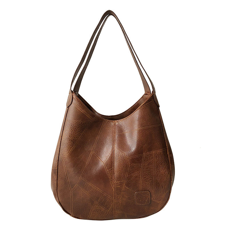 Brown leather handbag on a white background