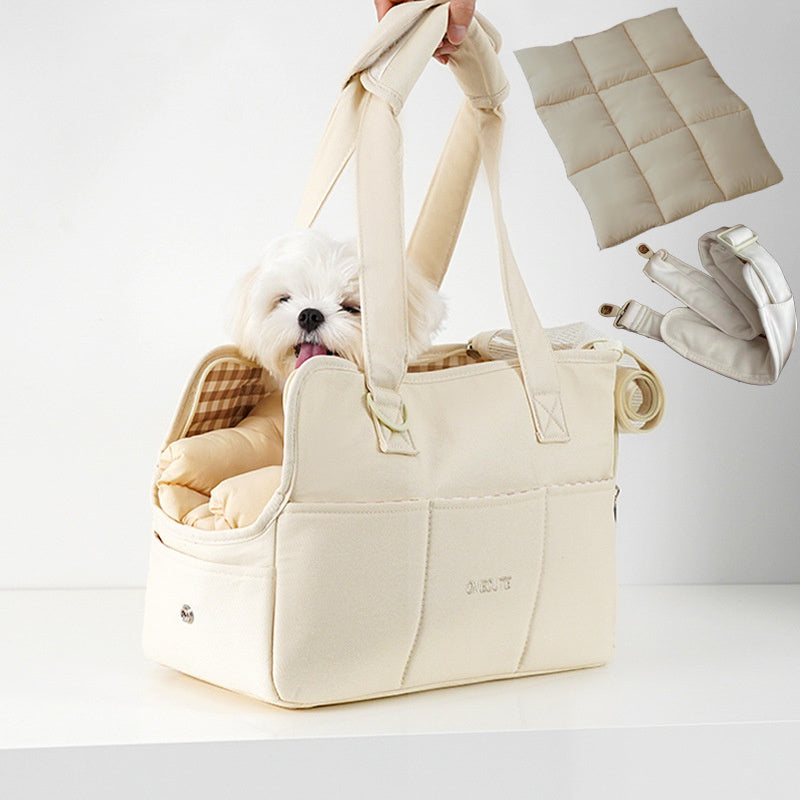 Beige pet carrier with a small white dog inside, on a light gray background.