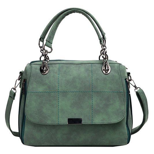 Green handbag with quilted design on a white background