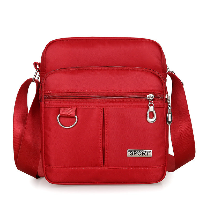 Red shoulder bag with 'SPORT' label on a white background