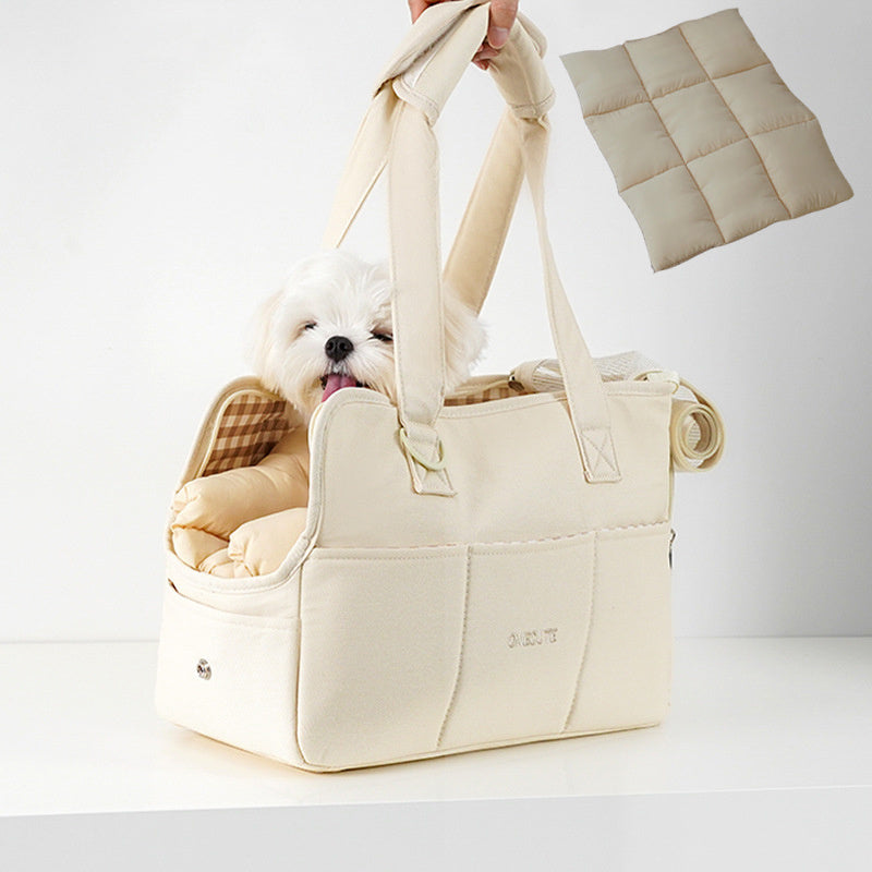 White dog in a beige pet carrier with a white background