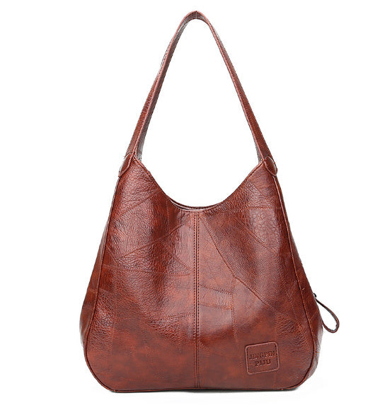 Brown leather handbag on a white background