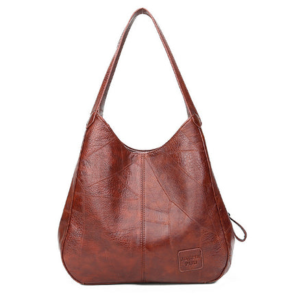 Brown leather handbag on a white background