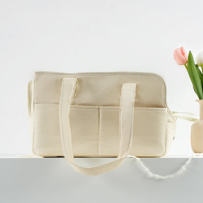 Beige tote bag with a vase of flowers on a light gray background