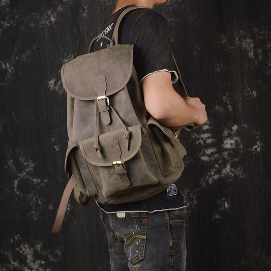 Person wearing a brown backpack against a dark textured background