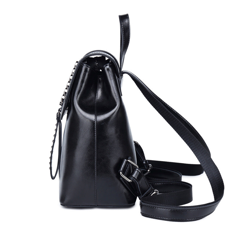 Black leather backpack with a strap on a white background