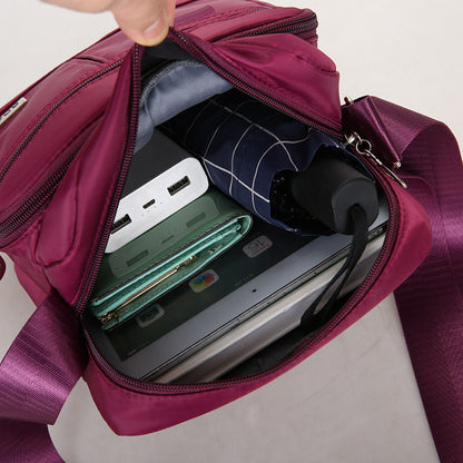 Purple backpack with electronic devices and items inside on a light gray background
