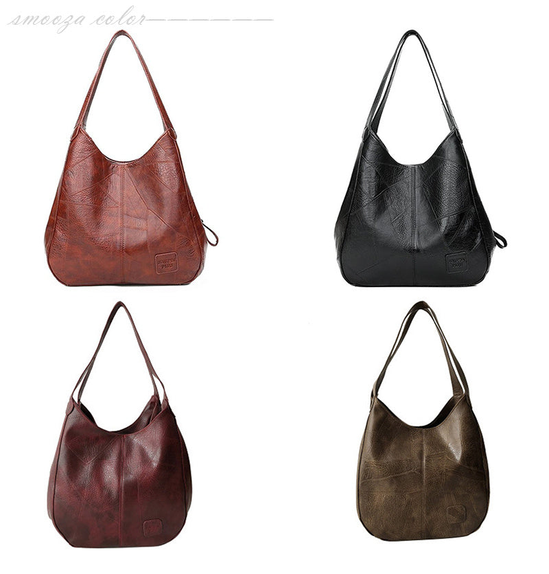 Four leather handbags in different colors on a white background