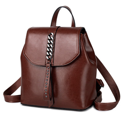 Brown leather backpack with chain detail on a white background