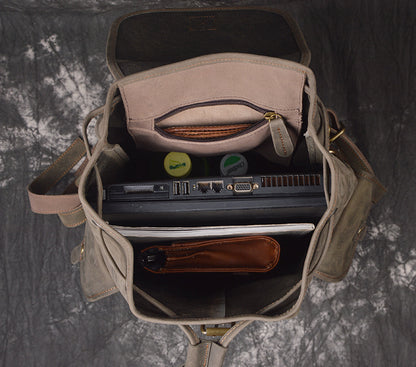Open bag with laptop and items on a textured gray background