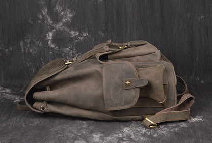 Brown leather bag with gold hardware on a dark textured background