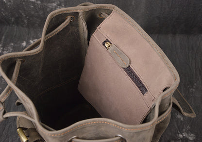 Beige leather bag with a zipper pocket on a dark textured background