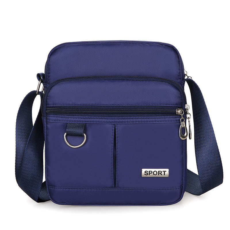 Blue crossbody bag with 'SPORT' label on a white background