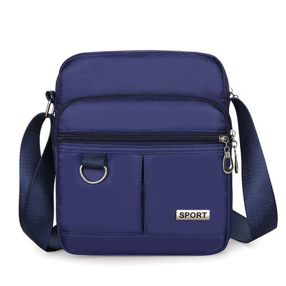 Blue crossbody bag with 'SPORT' label on a white background