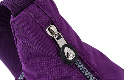 Close-up of a purple bag with a silver zipper on a white background